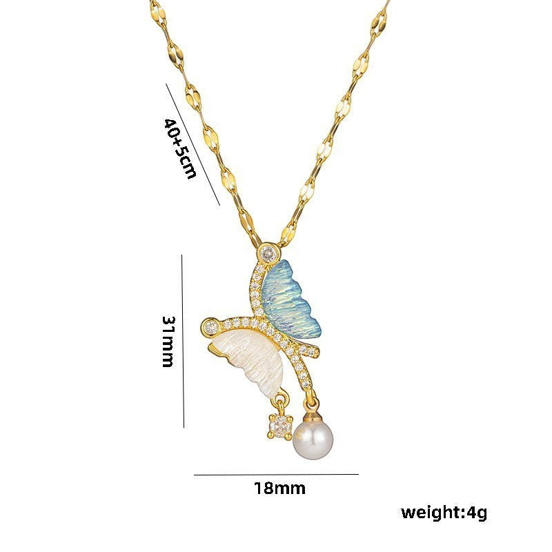 32lavender asymmetrical butterfly necklace with blue and white wings, pearl drop, and cubic zirconia accents on a gold chain.