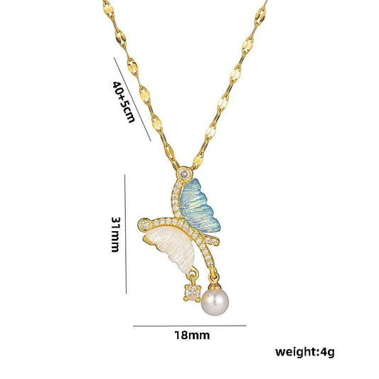 32lavender asymmetrical butterfly necklace with blue and white wings, pearl drop, and cubic zirconia accents on a gold chain.