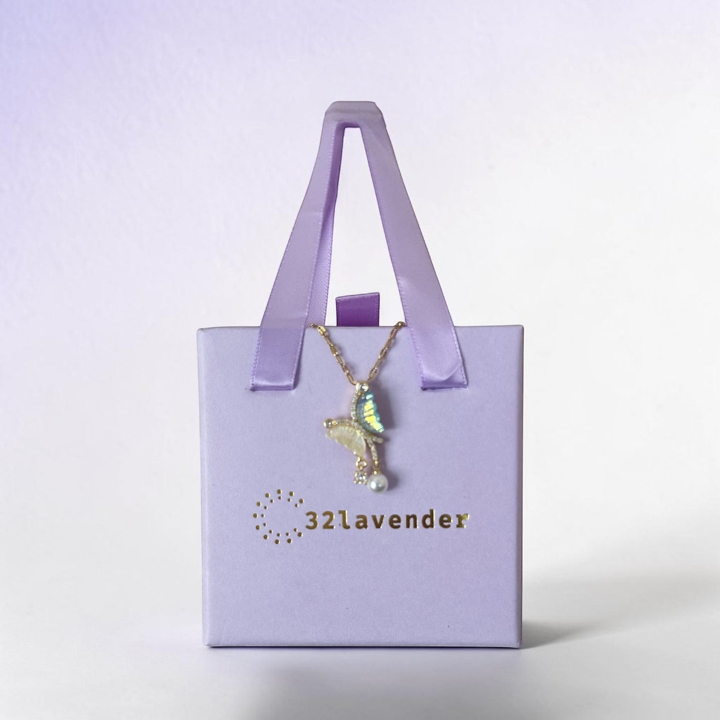 32lavender asymmetrical butterfly necklace with pearl and iridescent wings, made of titanium steel.